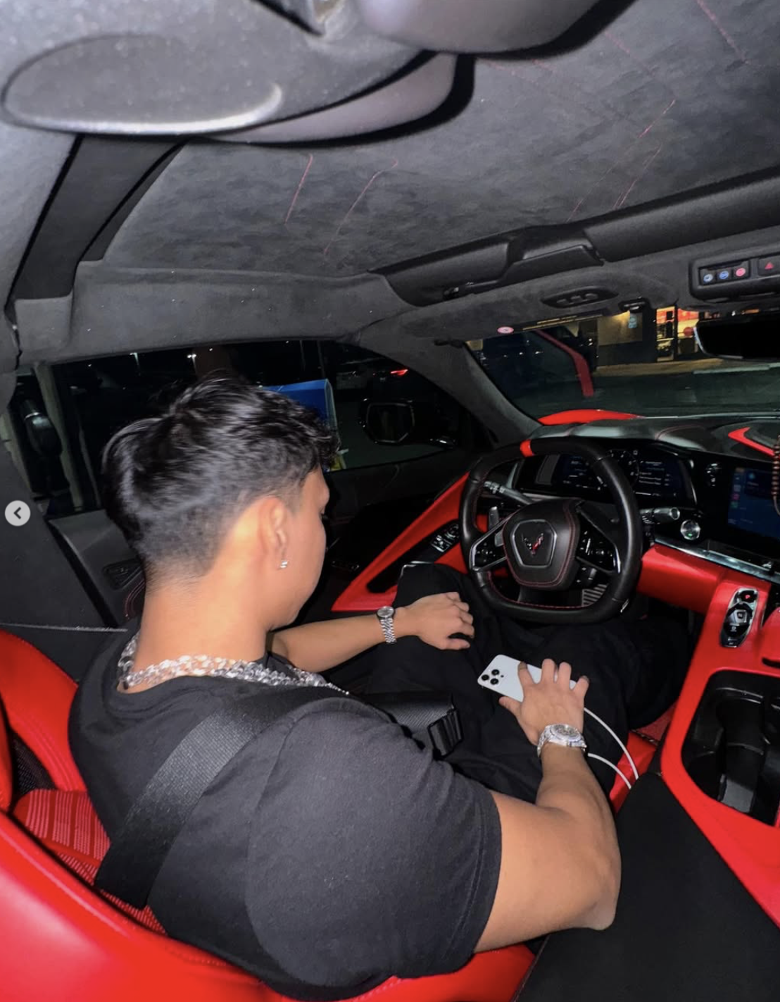 Founder sitting in a Corvette with red interior